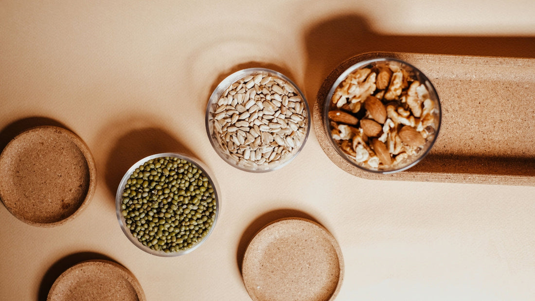Brazil nuts, seeds and bowls of grains on a counter
