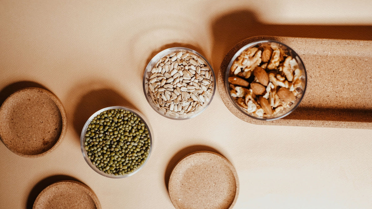 Brazil nuts, seeds and bowls of grains on a counter